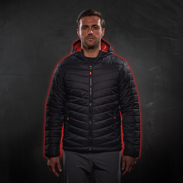 Man wearing a black puffer coat with red accents on a dark background.