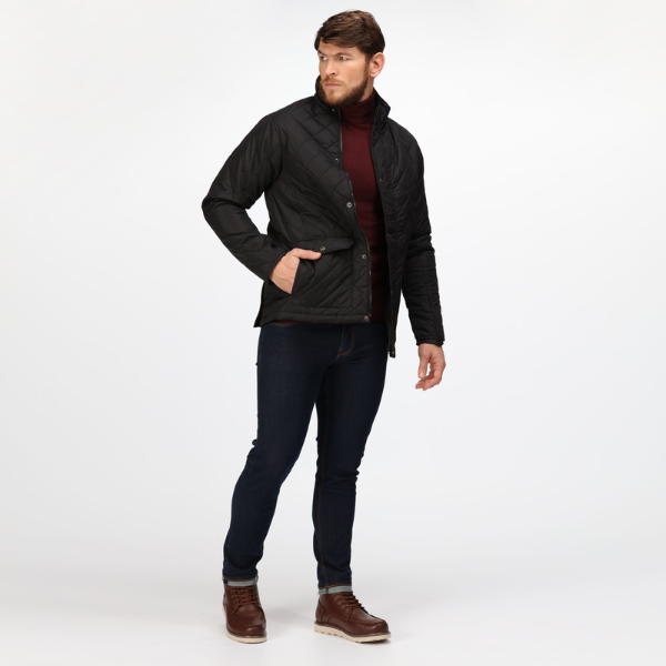 Man wearing a black jacket, dark jeans, and brown boots on a white background. Regatta Tyler Jacket TRA441. Regatta Professional Range.