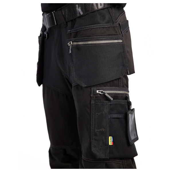 Close-up of the left zip pocket on Blaklader 15991860 Black Craftsman Work Trousers, detailing pocket size and reinforcement.