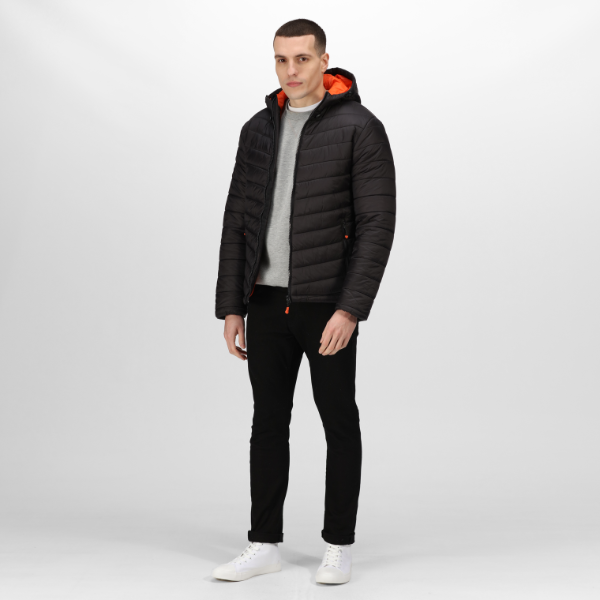 Man wearing a black puffer jacket with orange interior on a white background. Full-length front-facing image of the Regatta TRA527 Heated Jacket in black worn with casual outfit – Kustom Workwear online outlet.