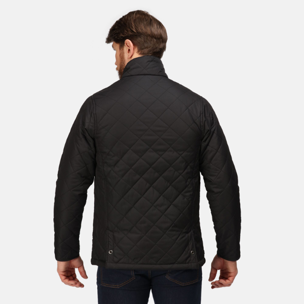 Man wearing a black quilted jacket on a white background.