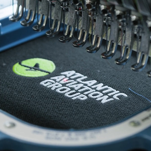 Embroidery, Printing & Transfers Close-up of embroidered Atlantic Aviation Group logo on a dark garment showing detailed threadwork and professional finish.