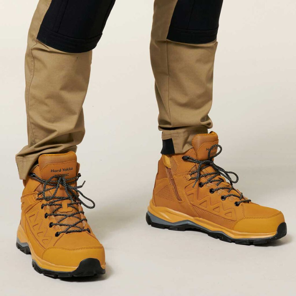 Wheat colour work boots with black laces worn by a person on a light background. Hard Yakka Atomic Safety Boot.