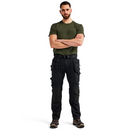 Model wearing Blaklader Craftsman Trousers Stretch 1750 in black, demonstrating ergonomic fit and practical workwear design.