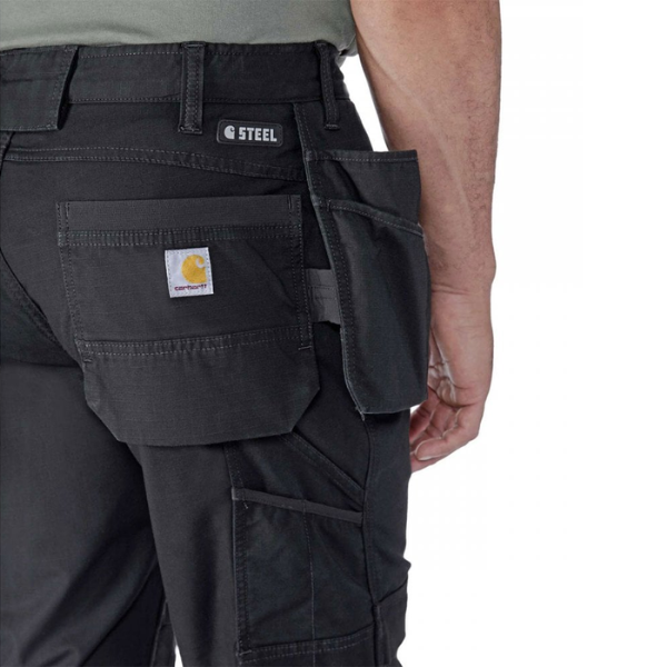 Black cargo pants with visible Carhartt branding on a white background