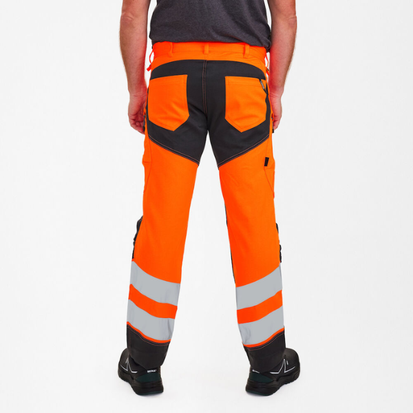 Safety pants on model, featuring contrast seat panel and double reflective bands.