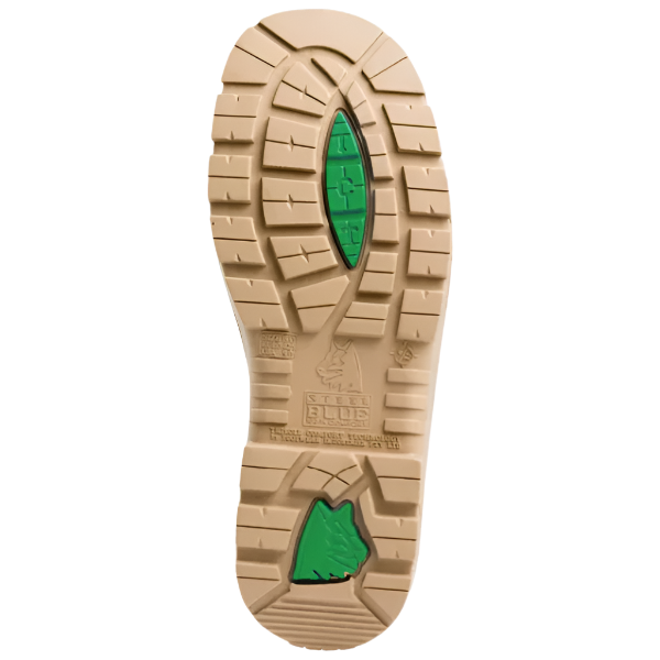 Close-up of a tan shoe sole with green accents on a white background. Slip-resistant outsole on Steel Blue safety boots offered by Kustom Workwear.