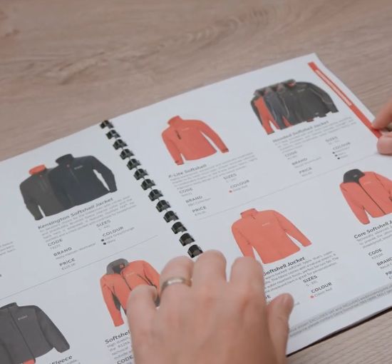 Custom workwear Ireland, browsing the Kustom Workwear catalogue during a product selection consultation