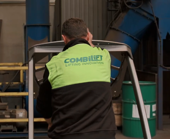 Worker wearing a branded hi-vis bodywarmer on the factory floor during a real-world workwear wearer trial in an industrial environment.