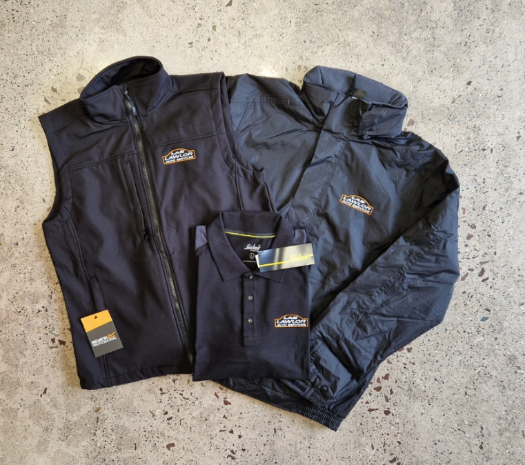 Navy softshell jacket, bodywarmer and polo shirt with embroidered company logo showing a complete branded workwear uniform set.