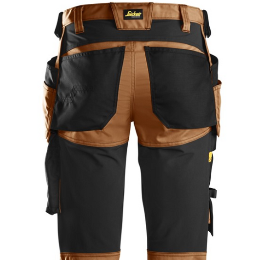 Black and brown pants with multiple pockets on a white background.