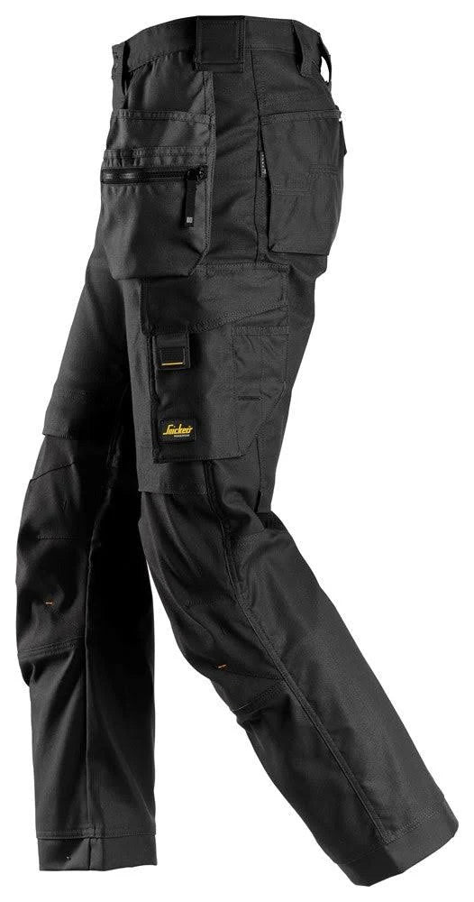 Left leg view of the Snickers 6244 black work trousers highlighting holster pocket layout and reinforced panels.