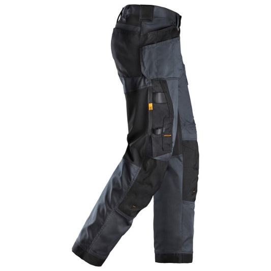 Snickers loose fit 6251 stretch work trousers with holster pockets, distributed by Kustom Workwear in Waterford. Designed with functionality in mind, these Snickers trousers feature flexible 4-way stretch zones and reinforced panels for performance-driven workwear professionals.