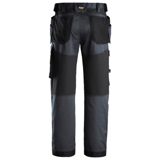Snickers Workwear 6251 trousers with holster pockets, sold by Kustom Workwear in Waterford, offering a professional-grade work trouser solution. Featuring Cordura® knee reinforcements, tool storage, and stretch fabric for tradespeople who value mobility and durability.