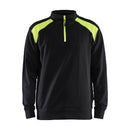 A black and green Blaklader 3353 half-zip 2-tone sweatshirt with a high collar and zipper.