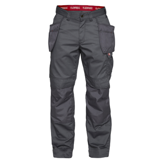 A pair of grey Engel combat trousers with hanging tool pockets, ergonomic knee pads, and adjustable hammer strap.